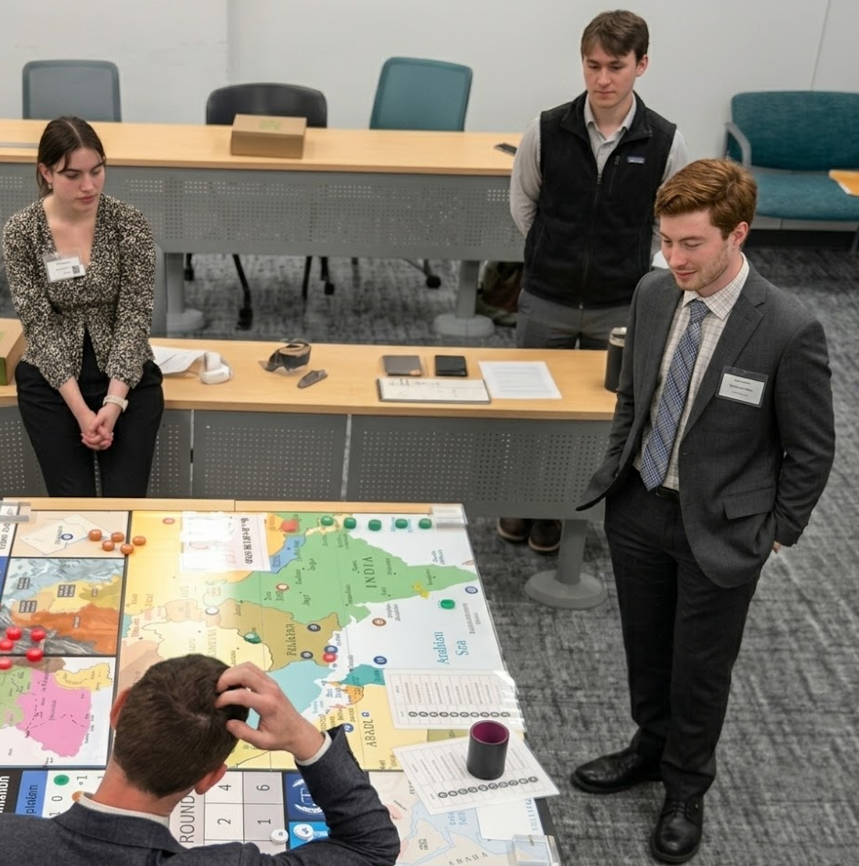 Students engage in a tabletop geopolitical simulation using a large map and game pieces.